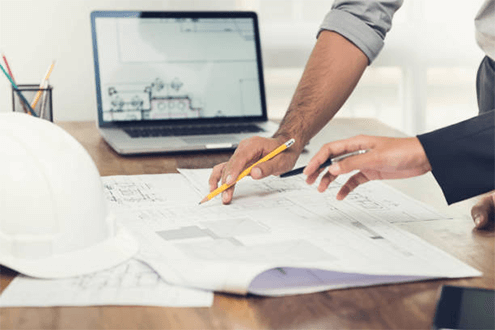 Construction estimating software-tycoonstory | tycoonstory media Professionals reviewing construction plans and discussing details, highlighting the importance of detailed planning in the success of construction projects.