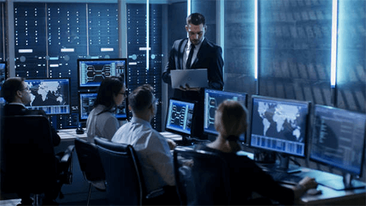 Highest salary jobs-tycoonstory | tycoonstory media Professionals working in a high-tech control room with multiple data screens, representing advanced careers and highest paying jobs in technology and cybersecurity fields.