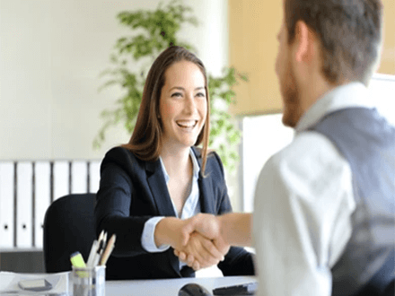 Suggestions for new hires Smiling professional shaking hands with a new hire during the onboarding process, marking the beginning of a successful professional relationship