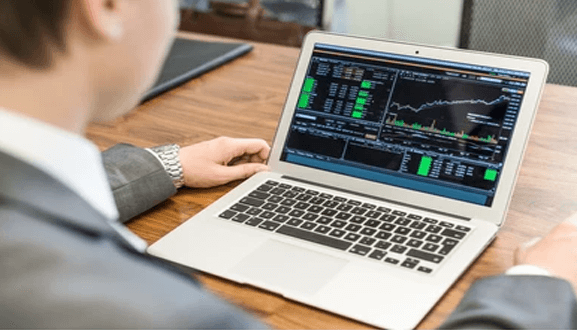 Advantages of web trader platform - tycoonstory | tycoonstory media Businessperson studying stock market data and financial charts on the laptop, dealing with trading, swissalliancefx..