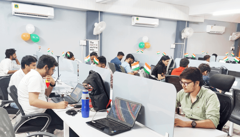 Flipshope Flipshope office workspace with employees working at their desks decorated with indian flags and balloons for a celebration.