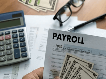 Paying payroll taxes A close-up of a payroll document and cash on a desk, symbolizing the financial management aspect of bootstrapping your business.