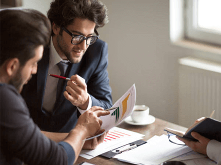 Settlement funds Settlement funding consultation showing legal professionals reviewing financial charts and documents together, highlighting that settlement funding does not depend on personal credit score.