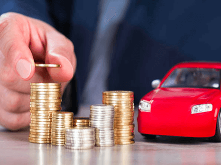 Help you buy a car Stacks of coins with a toy car, representing the financial planning involved in securing a personal loan for car purchase or related expenses.