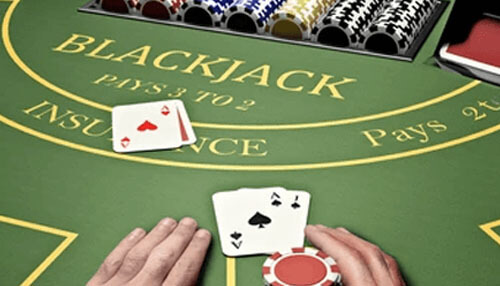 Blackjack Casino game: a blackjack table with cards, chips, and game rules such as'Blackjack Pays 3 to 2,' which one of the popular Casino Games many players around the world enjoy playing.
