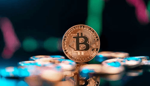 Green bitcoin A single bitcoin coin standing upright on a reflective surface, with blurred market chart lights in the background, representing bitcoin trading, digital currency markets, and cryptocurrency price movement.