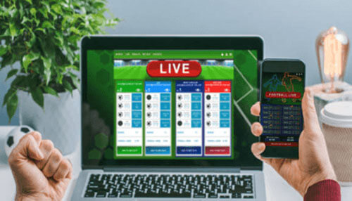 Live betting A stack of dollar bills placed in front of various sports balls, symbolizing the concept of bet on sports across different games.