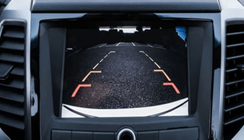 Rear cameras A car’s dashboard screen displaying a rear-view backup camera, representing one of the coolest things to buy online for enhancing vehicle safety.