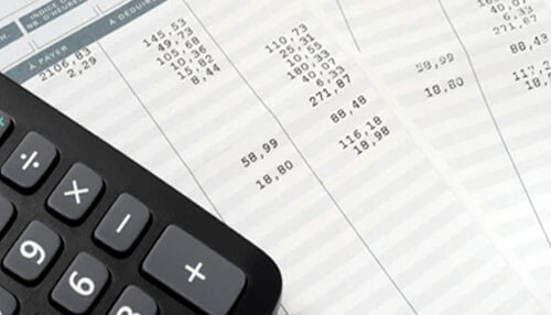 Wrongly calculating payroll - tycoonstory | tycoonstory media Payroll sheets and a calculator, representing how to handle payroll calculations.