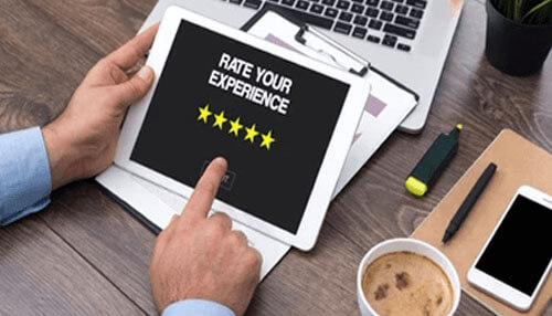 Importance of customer support Person using a tablet to give a five-star rating, representing customer feedback and satisfaction in startup customer service.