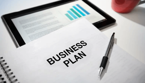 Create a business plan Business plan document with a pen on a table, representing strategic planning and business development.