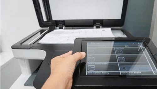 Document scanning technologies Hand operating the touchscreen of a modern document scanner with multiple scanning options displayed.