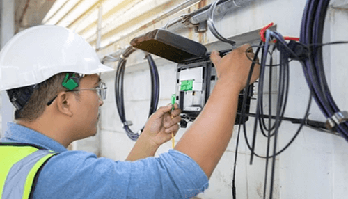 Cable tv provider Technician installing and connecting equipment for a cable tv provider, ensuring proper setup and functionality.