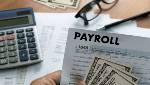 Payroll services Payroll document with cash and calculator, representing the services offered by a dallas cpa firm for managing business finances and taxes.