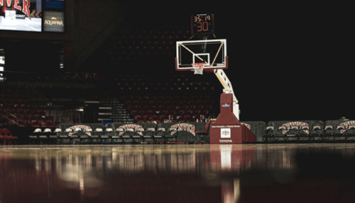 Sports betting on tennis Empty basketball court at a stadium, a representation of professional sports used in sports handicapping