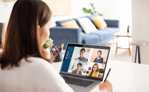 What is the hybrid work model Employee participating in a virtual meeting, highlighting the balance between remote and in-person collaboration in a hybrid workplace, fostering corporate culture.