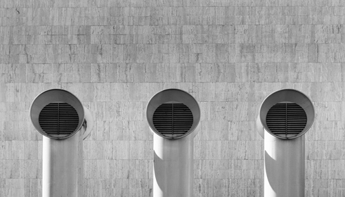 Ventilation and watering systems Ventilation pipes on a wall, essential for air circulation in a cannabis indoor grow setup.