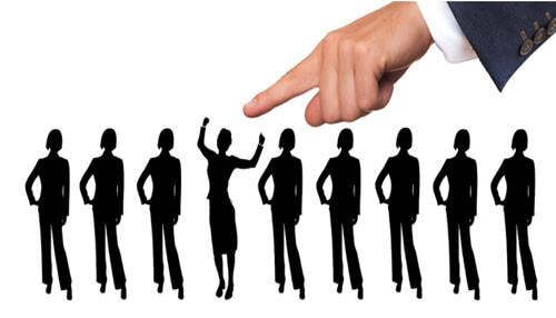 Ai is transforming workplace Illustration of a hand pointing to a standout figure among silhouettes, symbolizing how ai is identifying top talent and reshaping hiring practices in the workplace.