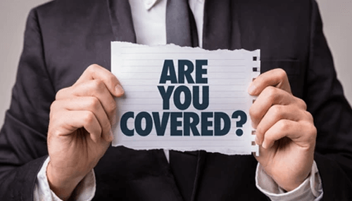 Insurance coverage A person in a suit holding a sign that reads are you covered? Related to personal injury insurance coverage.