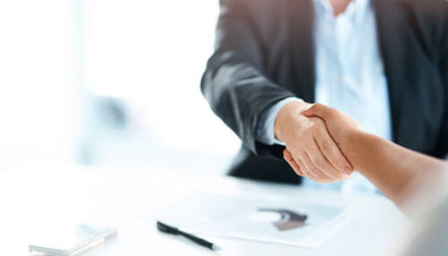 Hire an accountant - tycoonstory | tycoonstory media Small business accounting partnership symbolized by a professional handshake after financial consultation and agreement.