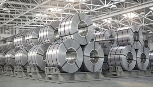 Infrabuild Stacks of industrial steel coils in a manufacturing warehouse, representing australia’s steel production and industrial sector