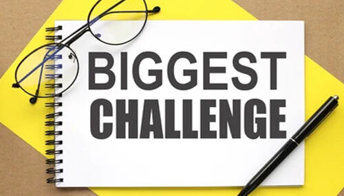 Biggest challenges for being successful in the industry - tycoonstory | tycoonstory media Stories flooring challenge concept shown by a notebook labeled “biggest challenge” with glasses and a pen, representing key obstacles and strategic planning in the flooring business.