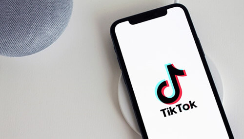 Tiktok marketing tactics Tiktok app open on a smartphone, showcasing the platform for implementing tiktok marketing tactics.
