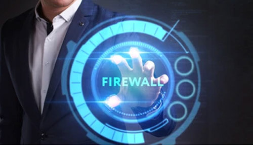 Use a firewall Close-up of three professionals in business attire collaborating at a wooden desk covered in detailed financial growth charts and analytical data, highlighting the collaborative strategy behind a successful business online.