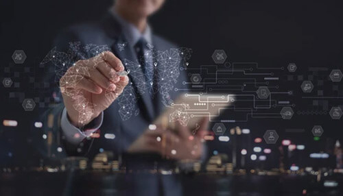 Improved demand and supply strategy - tycoonstory | tycoonstory media End-to-end supply chain innovation concept. A businessman interacting with a digital interface showing global technology icons.