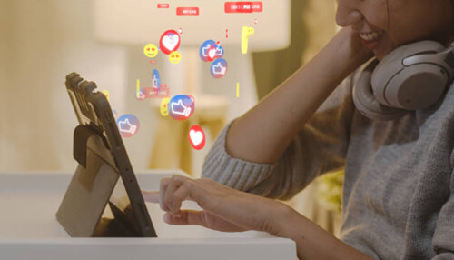 User engagement Facebook algorithm engagement illustration with user interacting on tablet and floating social media reaction icons.