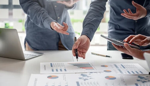 M1 finance M1 finance investment planning session with professionals discussing financial charts and data to make informed portfolio decisions.