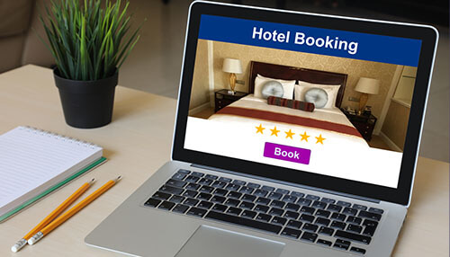 Book online Hotel revenue management displayed on a laptop screen featuring online hotel booking, ratings, and reservation tools.