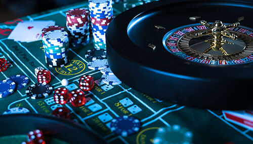 Casino net betting A casino betting scene featuring roulette, colorful chips, dice, and playing cards, capturing the excitement of casino net betting.