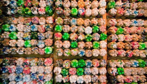 Eco-bricks made from recycled plastic bottles, showcasing innovative solutions for recycling and replacing plastics as sustainable building materials. Recycling and replacing plastics