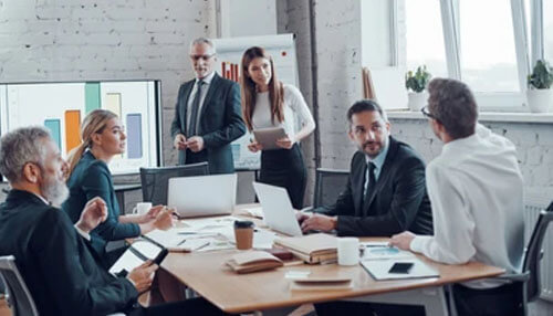 First board meeting private limited company Corporate team discussing business reports and strategies during an annual compliance meeting.