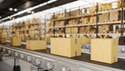 Flat belt conveyor system, one of the common types of conveyor belts used in warehouses for efficient transportation of boxes and goods. " Types of conveyor belts