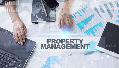 Keeping your property up to code A professional setting with technology and charts displaying property management data, representing the role of landlords in managing their properties.