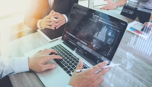 M1 finance M1 finance used for digital investment analysis, showing professionals reviewing portfolio data and market performance on a laptop.