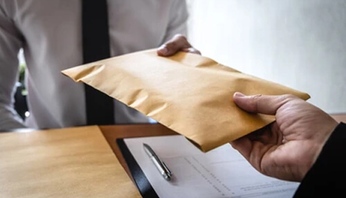 Person handing over a sealed envelope representing business payoff or confidential transaction in a successful roi analysis. Successful roi analysis