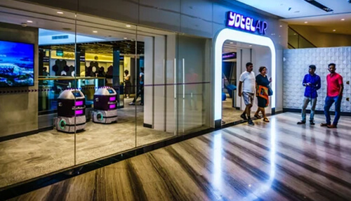 Yotelair istanbul airport The entrance of yotelair at istanbul airport, modern in design with robotic assistants and travelers walking by.