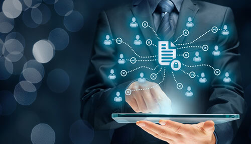 Businessman using a tablet, representing data quality management in business intelligence trends. Business intelligence trends