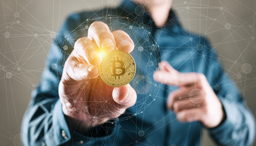 Bitcoin in the usa Businessman holding a bitcoin in hand, symbolizing digital currency investment and blockchain technology.