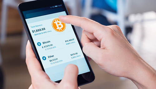 Invest in bitcoin Person using a smartphone crypto wallet app to review balances and invest in bitcoin securely.