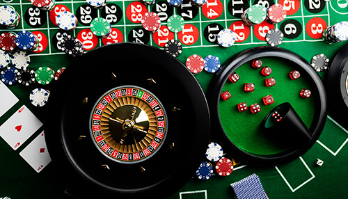 Gambling Close-up of a roulette wheel and poker chips on a casino table, showing the thrill of gambling in a casino setting.