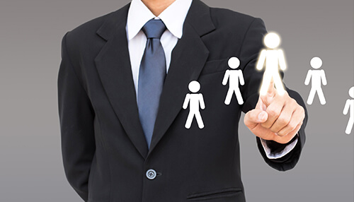 Human resource - tycoonstory | tycoonstory media A businessman pointing a person icons with a gray background it represents human resource consulting services for businesses.