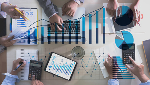 Team analyzing charts and data representing the impact on revenues, highlighting the difference between b2b and b2c customer service strategies. B2b and b2c customer service impact on revenues