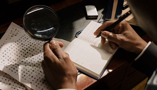 Investigation Investigator reviewing notes with a magnifying glass while gathering evidence to support a personal injury lawsuit claim.