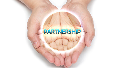 Restaurant ownership Restaurant ownership partnership concept shown by two hands holding a glowing circle with the word “partnership,” symbolizing shared restaurant ownership and collaborative business management.