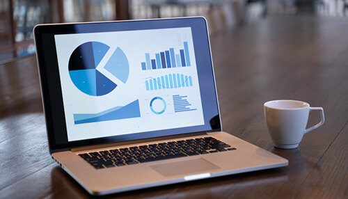Sales revenue Small business data analysis on a laptop, displaying various graphs and statistics for performance tracking and growth.