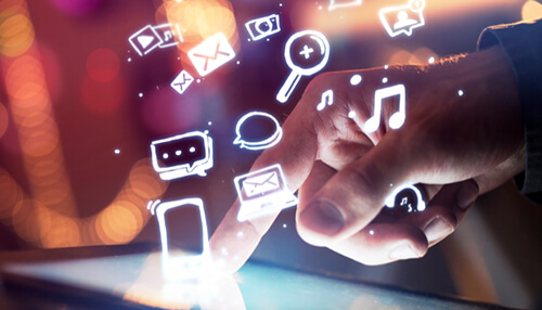 Finger interacting with digital icons on a touchscreen, representing the use of social media as part of a product development strategy. Product development strategy